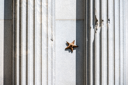 The bronze stars on the outer walls of the State House mark the spots where cannonballs struck the granite walls. The shots were fired by northern artillerymen on February 17, 1865, during General William Tecumseh Sherman's occupation of Columbia.