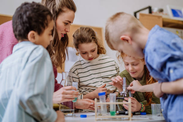 istock Young teacher doing chemistry experiment with pupils during science education. 1484143735