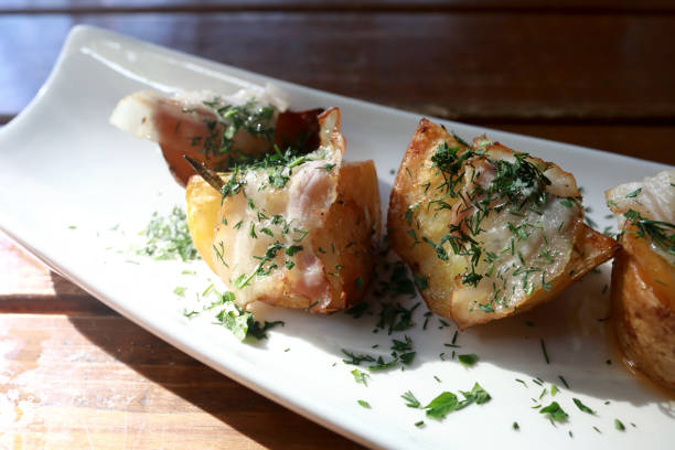 istock Potato baked in bacon on white plate 1484147216