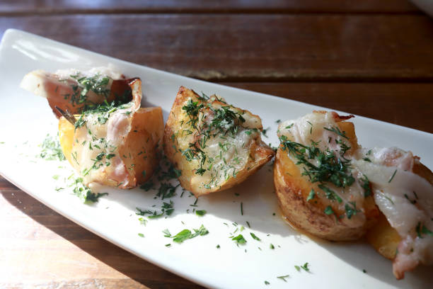istock Potato baked in bacon on plate 1484147222