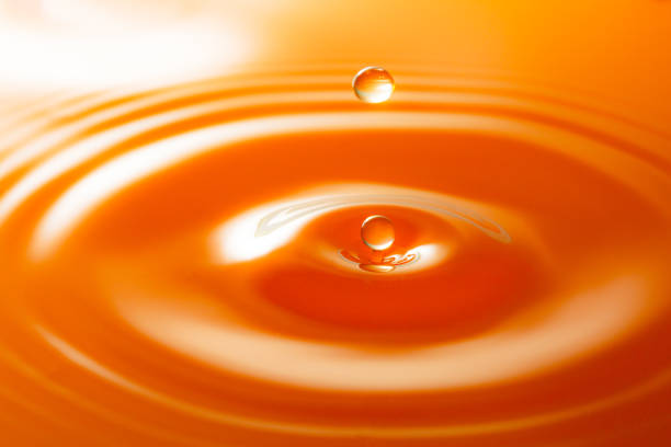 istock Macro orange drop,Macro orange water drop texture,Falling drop in orange water with splash,The waves after a few drops of orange juice 1484148541