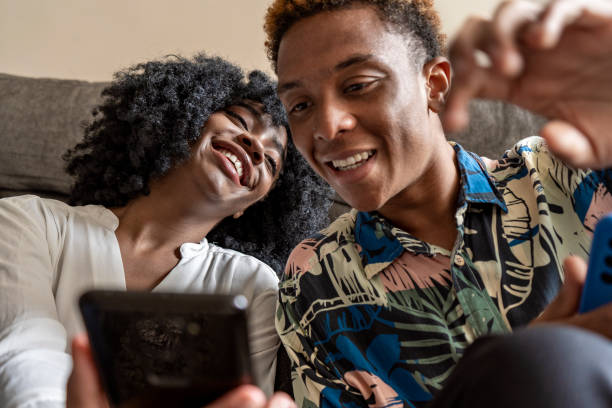 istock A couple uses a smartphone device, sitting in a living room 1484149086