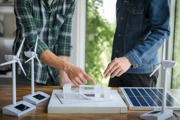 istock Close-up at tablet, Engineers pointing at tablet with their hands. To jointly design the use of renewable energy with wind and solar energy. Concept of using renewable energy. 1484149200