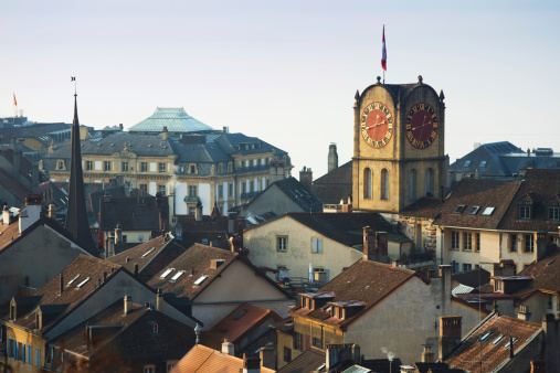 Neuchatel old town building's roof and clock tower in the winter morning