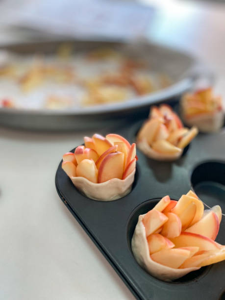 istock Mold with apple puff pastry roses ready to bake 1484153894