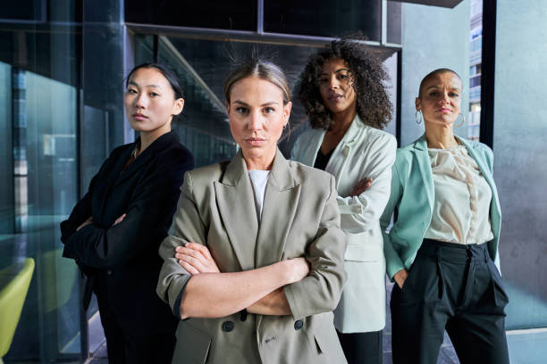 istock Four multiracial empowered women looking at camera confident and serious at the office. 1484154876