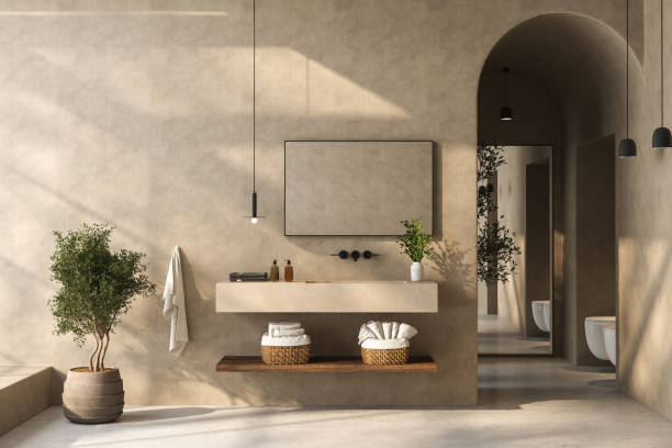 istock A minimalist bathroom with a sleek bathroom vanity, black and white bathtub, wall-mounted mirror, plants, matte marble flooring, beige walls, and a small pool. 3d rendering 1484156621
