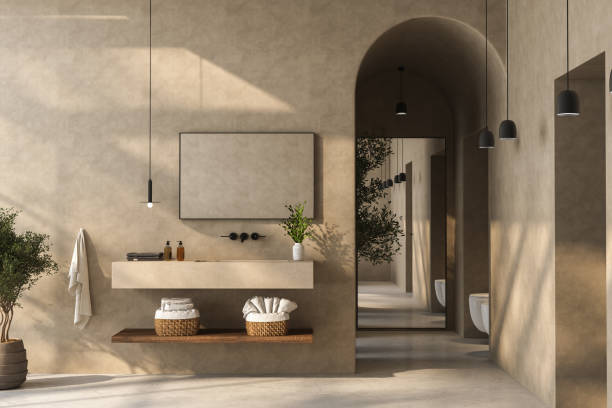 istock A minimalist bathroom with a sleek bathroom vanity, black and white bathtub, wall-mounted mirror, plants, matte marble flooring, beige walls, and a small pool. 3d rendering 1484156625