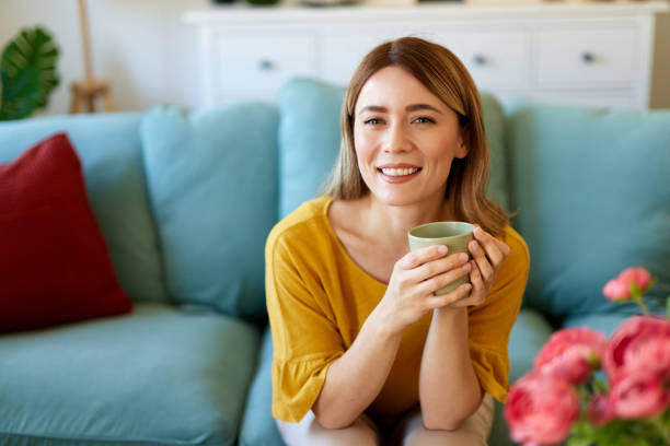 istock An attractive young woman relaxing at home drinking coffee 1484157375