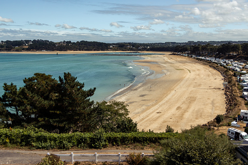 very touristic beach with a campground next to it in brittany
