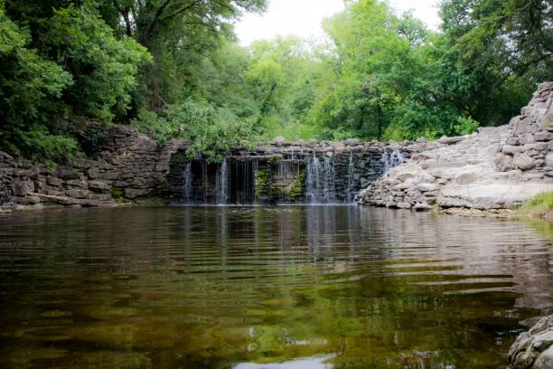 istock Stunning image of a tranquil cascading waterfall spilling into a sparkling pond 1484159979