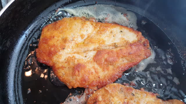 Breaded chicken being fried