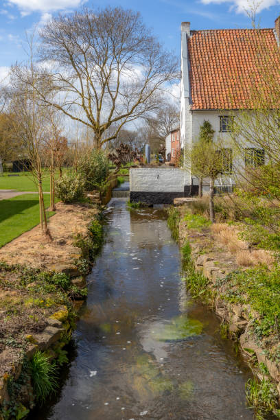 Thornerbeek stream and old Kraekermolen watermill in background, reflection on water surface stock photo