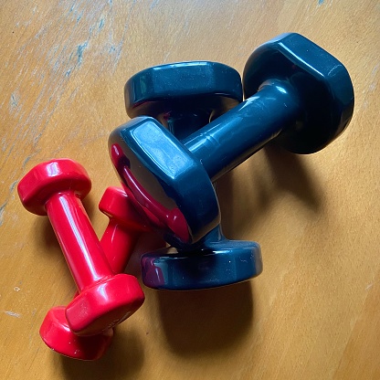 Weights for sports training. Gym equipment. Hand dumbbells 1kg and 2kg. White or neutral background and texture.