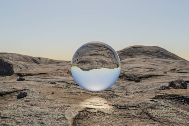 istock single glas sphere ball hovering in the air in large empty desert environment; abstract surreal concept; 3D Illustration 1484164139