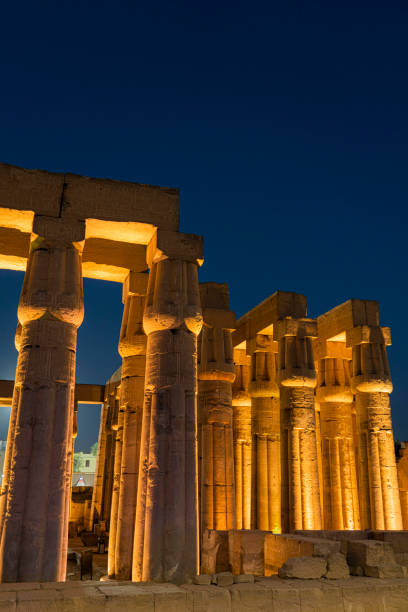 Wide view of the temple lighted at night.