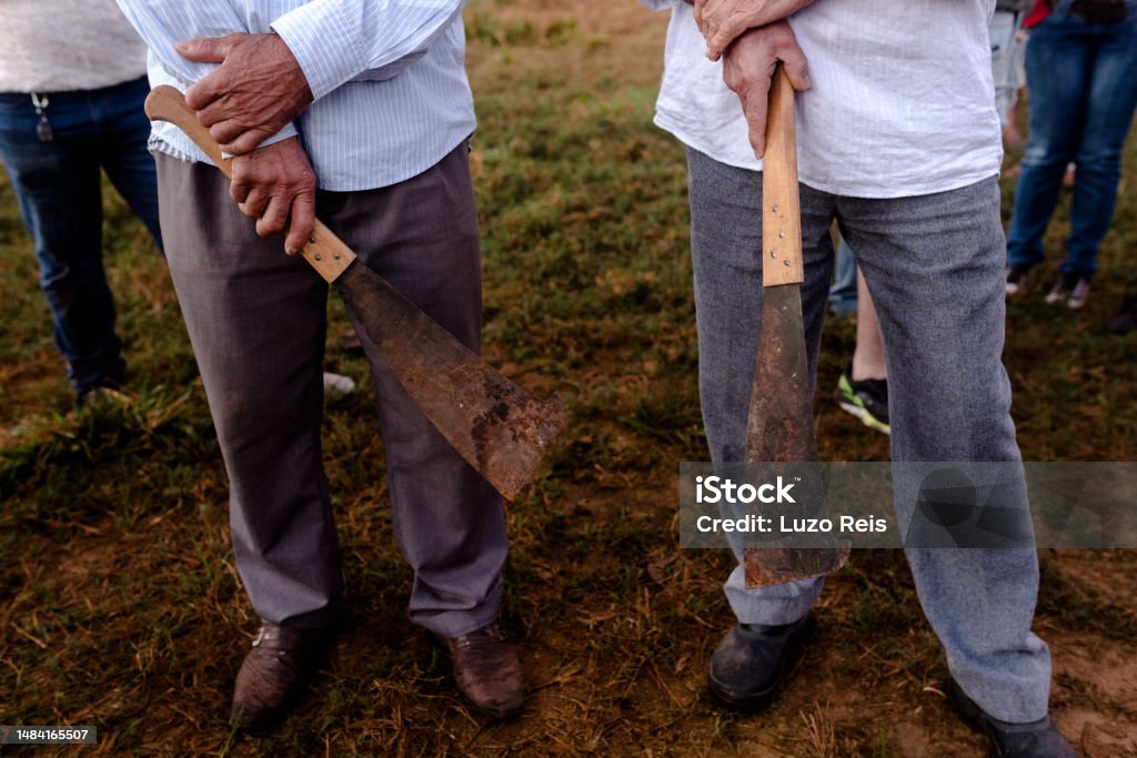 Workers holding cane cutting machetes Jaciara, Mato Grosso, Brasil - July, 13, 2015 - detail of the hands of workers from the "Movimento Sem Terra" (MST) holding cane cutting machetes Activist Stock Photo