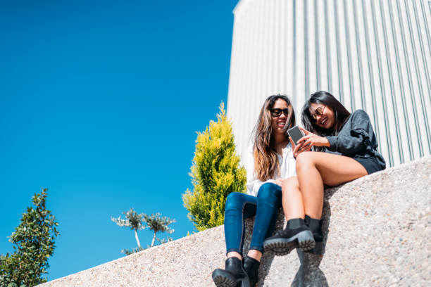 istock Cheerful women sitting on stone 1484167541
