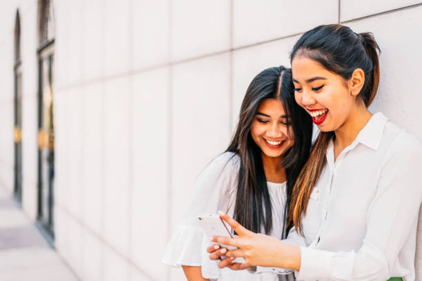 istock Cheerful Asian woman using smartphone 1484167577