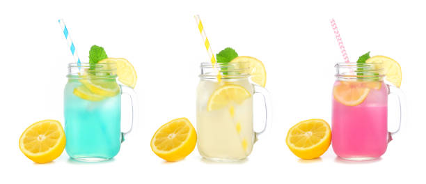 istock Colorful summer lemonade drinks in mason jar glasses with lemons isolated on white 1484168568