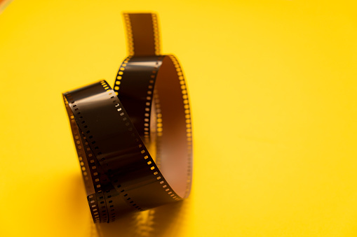 Old 35mm film on a yellow background