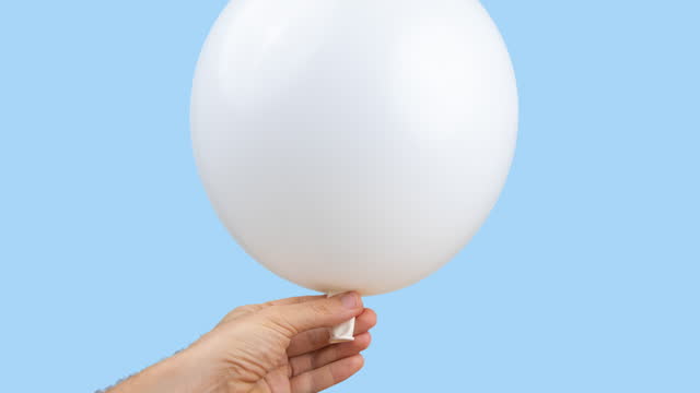 blow up balloon in hand
