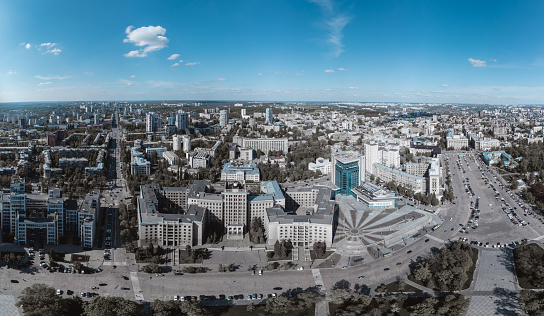 Aerial wide panorama view on Karazin National University northern building on Freedom square with blue sky in Kharkiv city, Ukraine. Color graded