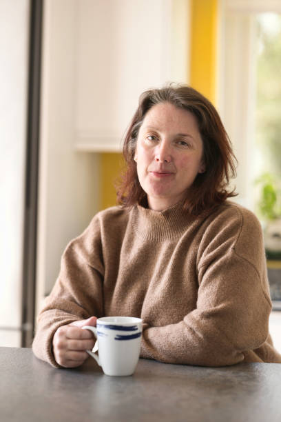 Middle-aged lady enjoying a coffee break