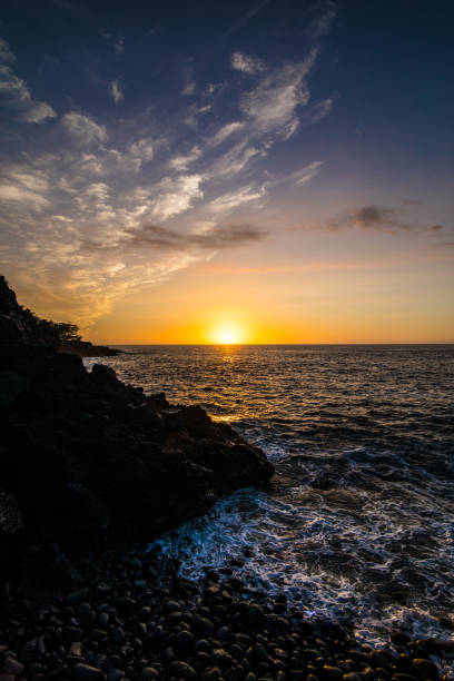 istock Sunset in Hawaii at Rocky Beach 1484176430