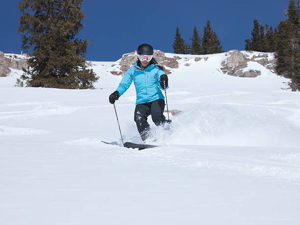 Young woman skiing in powder snow, Colorado, USA. stock photo