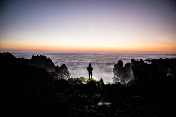 Man Standing Alone Epic Oceanview Sunset Contrast Hawaii. Symbolic of depression, afterlife, loneliness, etc.