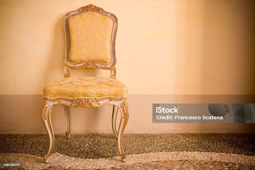 Ancient italian wooden padded chair just restored with floral decorations - image with copy space Italian Culture Stock Photo