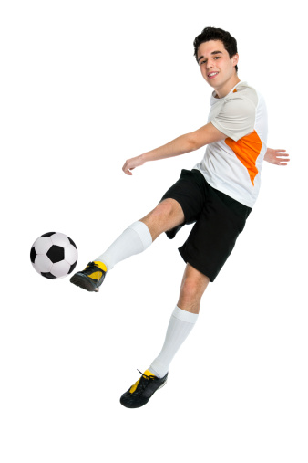 soccer player shooting a ball isolated on white background