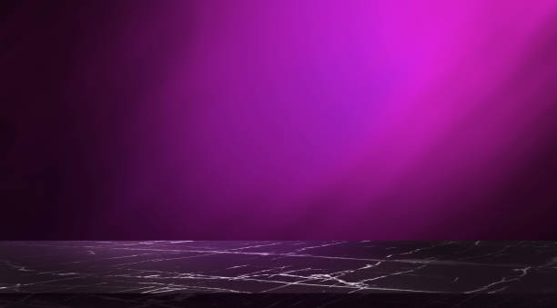 empty luxury marble table for product displayed. elegant violet scene for business advertising. dark black polished marquina stone marble table at foreground on blurred purple pink light background.