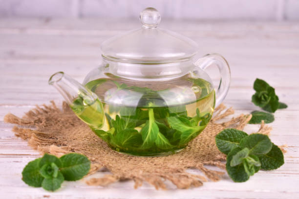 istock Mint tea with fresh mint leaves in a glass teapot.Close-up. 1484181873