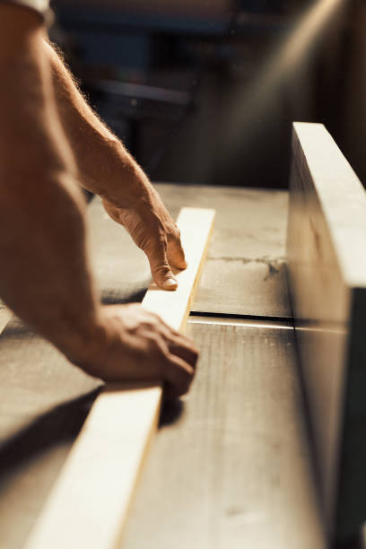 istock Carpenter's strong hand holds metal tool 1484183401