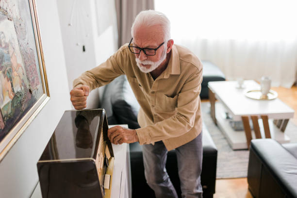 istock An elderly man angry at a broken radio 1484183860