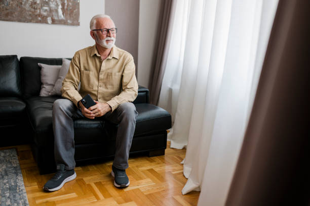 istock Smiling Elderly man grandfather using smart phone, searching web, loading feed, social media. Communication with children, grandchildren on lockdown 1484183996