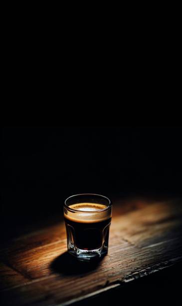 istock A delicious espresso standing on a wooden table with overhead light 1484187371