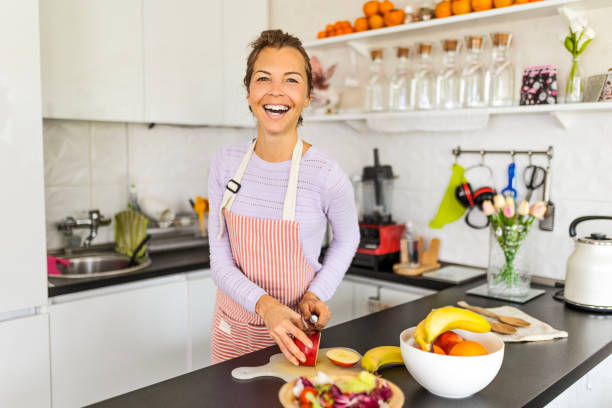 istock Woman making fruit salad cutting apple 1484191110