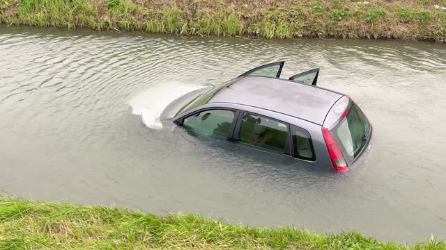 A car submerged in flood water, road accident