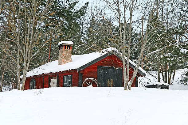 istock Rustic red wooden barn in snow 148420109