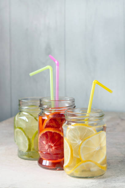 istock lemonade from lemon, lime, orange in glass jars on the table, copy space 1484201135