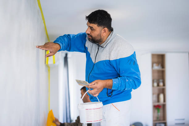 Man painting the wall carefully