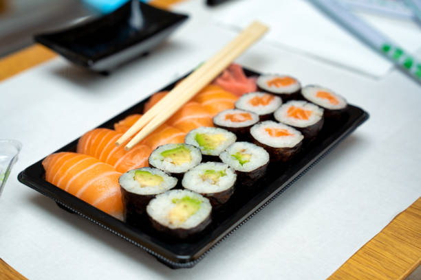 Tasty Pieces of sushi on white background