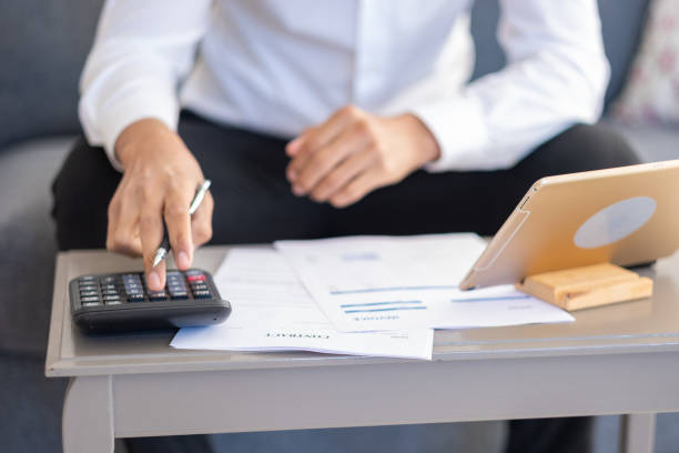 istock Unrecognizable businessman calculating bills 1484213640