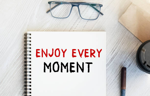 istock Notepad with the inscription KNOWLEDGE IS POWER. Paper cup with coffee and paper bag with breakfast on the table. View from above. Marketing concept. 1484218521