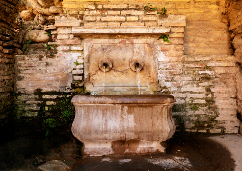 Ancient fountain in Alhambra gardens, Granada, Spain