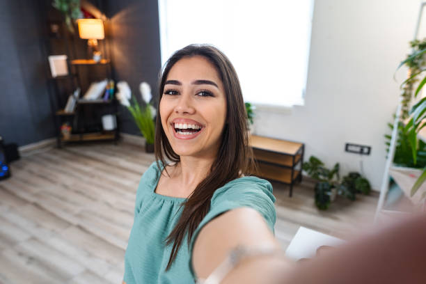 istock Smiling young woman in apartment 1484219030