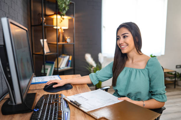 istock Young woman working on a computer at home 1484219643